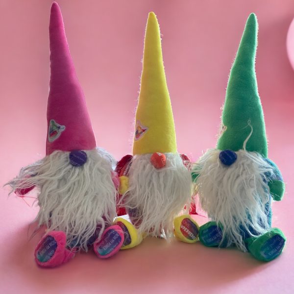 Three vibrant gnomes in whimsical garden scene