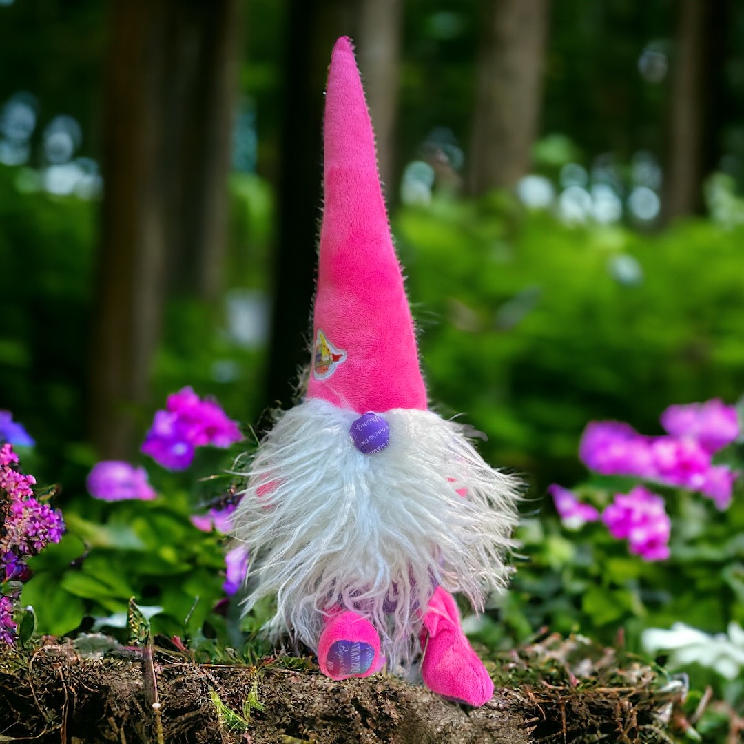 Pink gnome with long white beard sitting on stump in serene scene